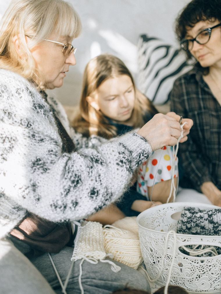 A family member and caregiver talking at a kitchen table