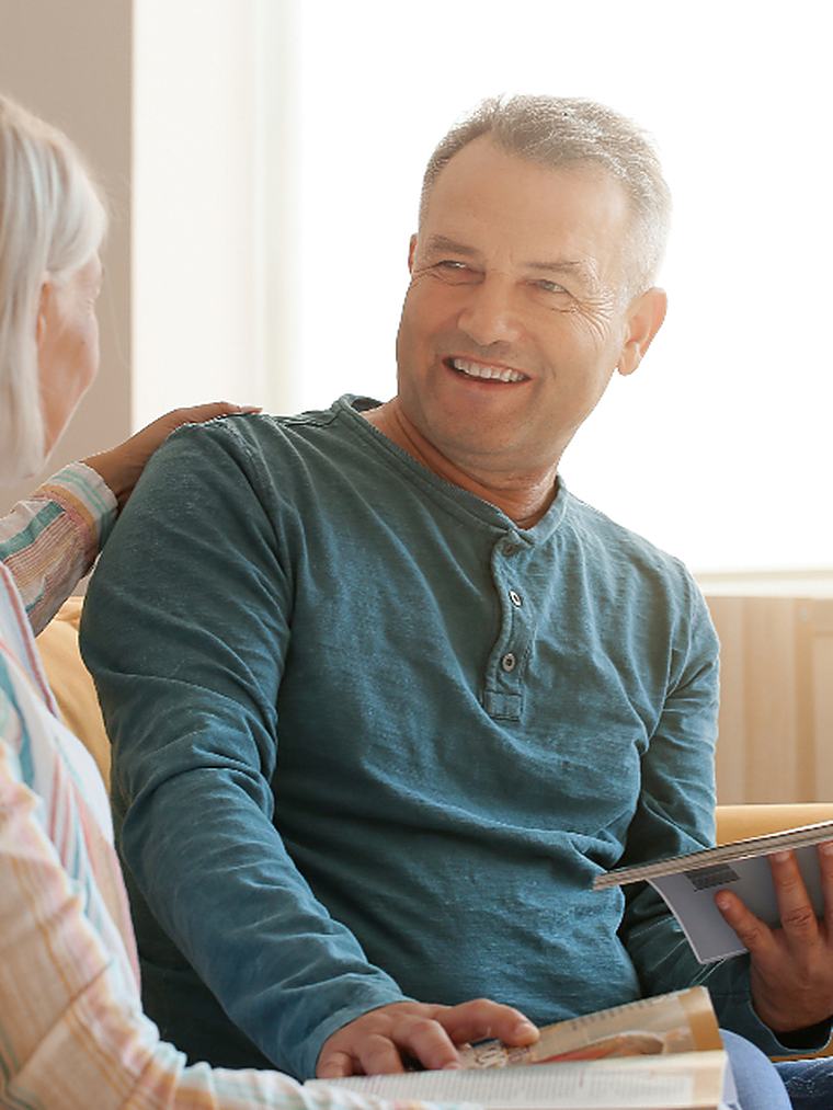 A caregiver and family member reviewing a care plan together